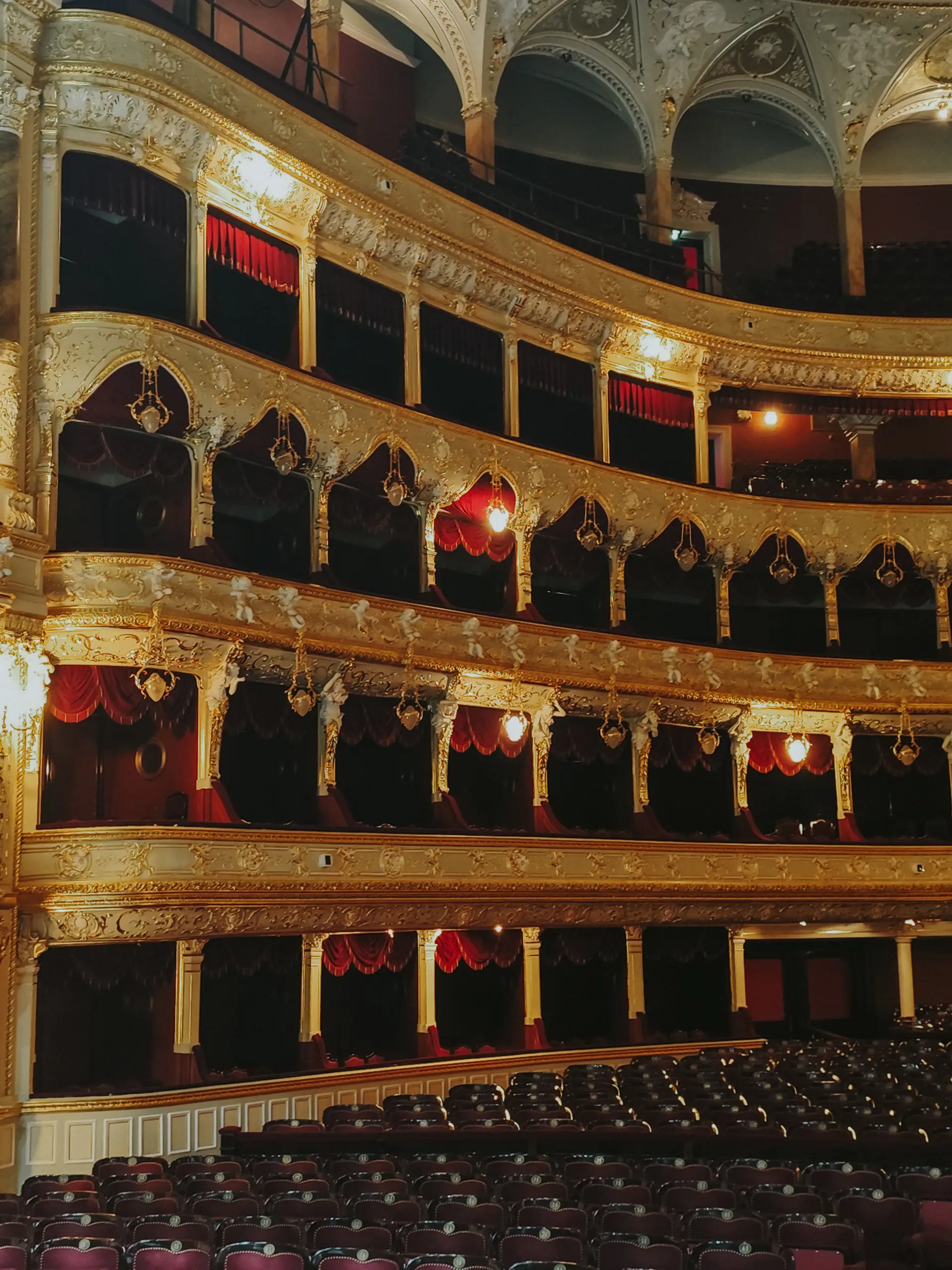 Ornate theater interior with red velvet seating